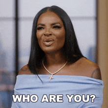 a woman in a blue off the shoulder top asks who are you