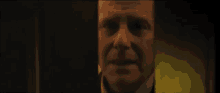 a close up of a man 's face with a yellow background