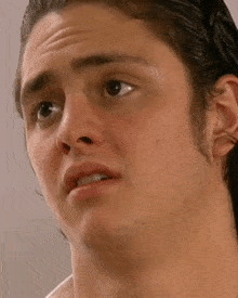a close up of a man 's face with a slight smile on his face