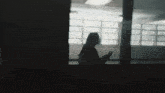 a silhouette of a woman in a dark room