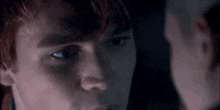 a close up of a person 's face looking at another person 's face