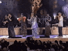 a group of men singing into microphones on a stage