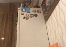 a white refrigerator with a bunch of magnets on the door