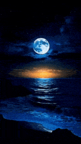 a full moon rises over the ocean at sunset