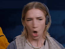 a woman wearing a headset making a funny face