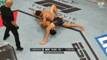 two men are wrestling on a ufc ring and the time is 2:28