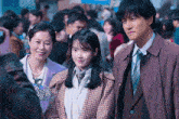 a group of people posing for a picture in a crowded area