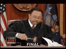 a judge is hitting a piece of paper with a hammer and the word final is on the screen .