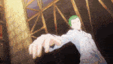 a man with green hair and a white shirt is reaching out his hand