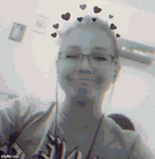 a black and white photo of a girl with hearts on her hair