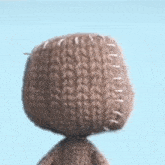 a close up of a stuffed animal with stitches on it 's head