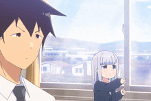 a man and a girl are standing in front of a window looking out