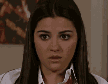 a close up of a woman 's face with a red tie