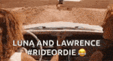 a woman is driving a car with the words `` luna and lawrence #rideordie '' written on it .