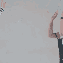 two girls are holding hands and smiling while dancing