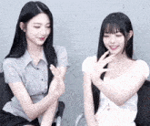 two girls are sitting next to each other and one is wearing a plaid shirt