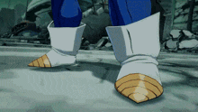 a close up of a cartoon character 's boots with a gold stripe on the toe