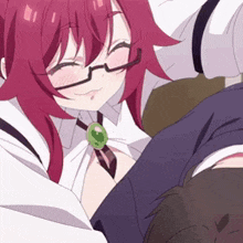 a girl with red hair and glasses is laying on a man 's lap .