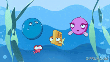 a group of fish are swimming in the ocean and the website gifrun.com is visible in the corner