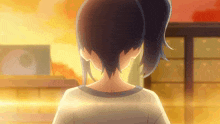 a girl with a ponytail is looking at something in the distance