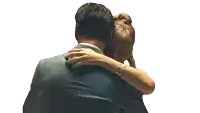 a man and a woman hugging each other with the woman holding her head