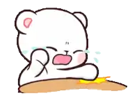 a cartoon bear is sitting at a table crying .