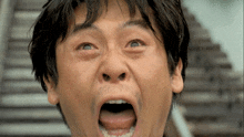a close up of a man with his mouth wide open