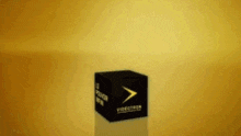 a videotech box is sitting on a yellow surface .