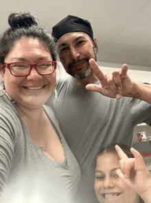 a man and woman are posing for a picture with a child