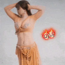 a woman in a belly dancer costume is standing in front of a white background .