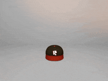 a baseball cap with the letter r on the front