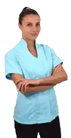 a woman with her arms crossed wearing a blue scrub top
