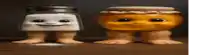 a salt and pepper shaker and a jar of honey are sitting on a table .
