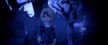 a doll with the letter m on its head is standing in a dark forest