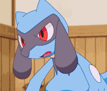 a blue cartoon character with red eyes and a white spot on his back