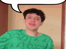 a young man wearing a green shirt with a speech bubble above his head