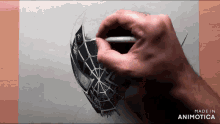 a hand is drawing a spider web on a piece of paper made in animatica
