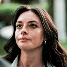 a close up of a woman 's face with her eyes closed