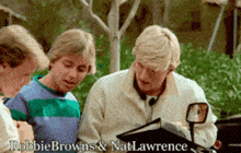 robbie browns and nat lawrence are looking at a clipboard