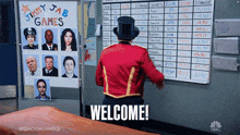 a man in a top hat stands in front of a welcome sign
