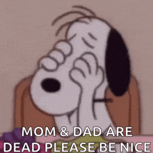 snoopy is sitting at a table with a plate of grapes and holding his head .