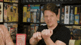 a man is holding a ring in front of a book titled would you still love me if