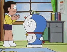 a cartoon character named doraemon is standing next to a boy .