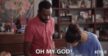 a man in a red shirt is standing next to a woman in a blue shirt and saying oh my god
