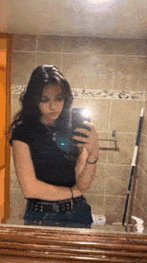 a woman taking a selfie in front of a mirror