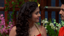 a woman with curly hair is looking at a man