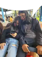 a girl wearing a gap sweatshirt sits next to another girl