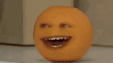 a red apple with a face on it is sitting on a table next to a box of eggs .