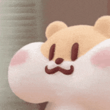 a close up of a stuffed animal with a mustache on it .