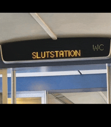 the word slutstation is on a sign above a doorway